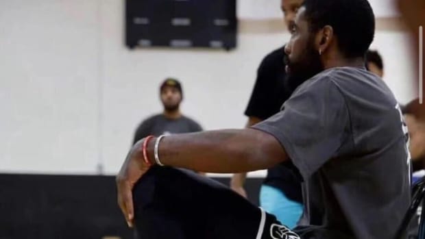 Kyrie Irving looks on during a basketball game.